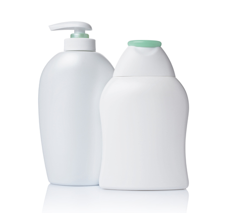 Blank white mockup dispenser and figured bottles of cosmetic products with green lid isolated on white backgroundの写真素材