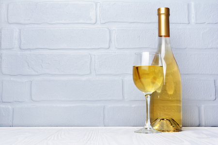 White wine bottle and glass for tasting on gray brick wall backgroundの写真素材