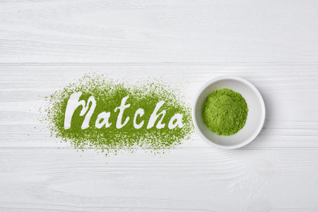 Top view on lettering from organic green matcha tea powder on white wooden backgroundの写真素材