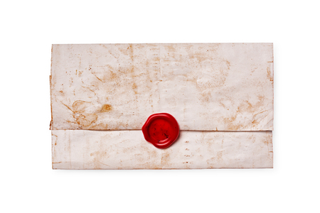 Old vintage yellowed paper letter closed with red sealing wax isolated on white backgroundの写真素材