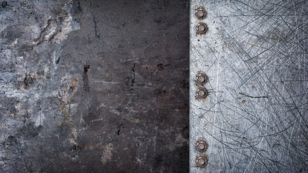 Grunge rusty and scratched metallic texture background with rivets for designの写真素材