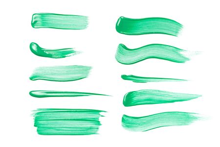 Set of green brush strokes of acrilic or oil paint as sample of art product isolated on white backgroundの写真素材