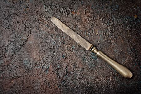 Top view of vintage silver cutlery or silverware on dark concrete background