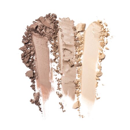 Brush strokes of crushed beige and brown eye shadow as sample of cosmetic product isolated on white backgroundの写真素材