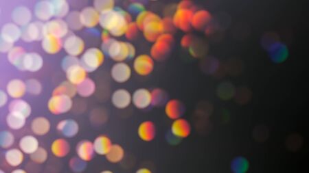 Defocused multicolored lights with bokeh effect on black background