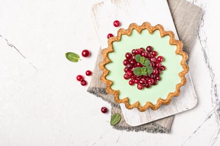 Top view of tasty berry dessert with fresh green mint on white marble background with copy spaceの写真素材