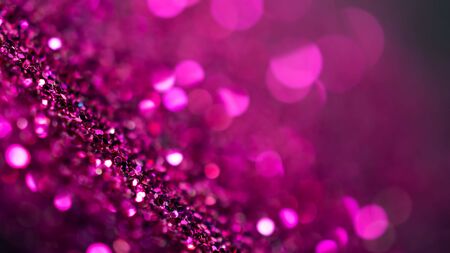 Defocused purple glitter and shimmer on abstract bokeh backgroundの写真素材