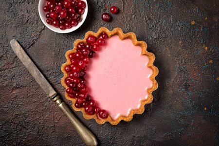 Top view of tasty berry dessert with vintage knife on dark grunge backgroundの写真素材