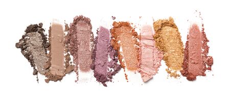 Flat lay of brush stroke. Broken shiny color eyeshadow as sample of cosmetic beauty product isolated on white backgroundの写真素材