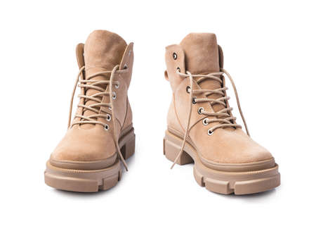 Fashion shoes with rough tread on sole. Beige leather boots on laces for street style isolated on...