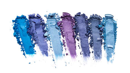 Flat lay of brush strokes. Broken shiny bright color eyeshadow as samples of cosmetic beauty products isolated on white backgroundの写真素材