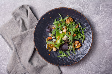 Top view of healthy and tasty vegetarian food. Salad with mix of fresh green leaves, blue cheese,...