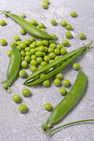 Fresh green peas for healthy nutrition on grey concrete backgroundの写真素材
