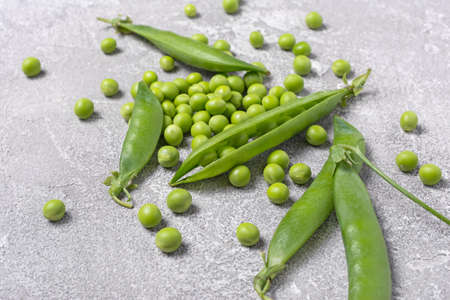 Fresh green peas for healthy nutrition on grey concrete backgroundの写真素材