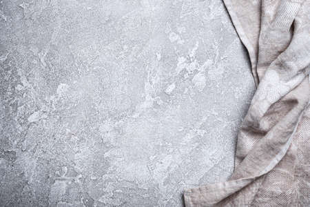 Top view of single folded linen serviette on grey concrete backgroundの写真素材