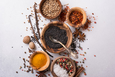 Top view of mix bright spices or seasonings in small wooden bowls as ingredient for healthy food on grey concrete backgroundの写真素材