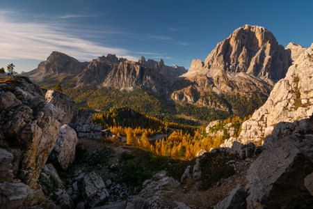 Morning landscape of beautiful autumn Dolomites Alps on blue cloudy sky backgroundの写真素材