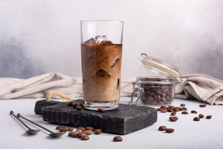 Homemade ice latte. Black coffee with ice and milk or cream in glass for tasty and refreshing break...