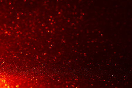 Bright shiny red glitter and shimmer on abstract bokeh backgroundの写真素材