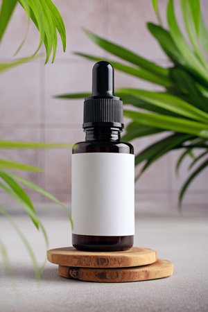 Serum bottle with white mockup label for cosmetic design. Minimal product display scene for serum or essence with brown glass dropper bottle.の写真素材