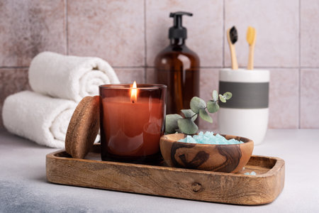 Scented candle, sea salt and bathroom accessories: towels, dispenser and bamboo toothbrush. Modern bathroom dÃ©cor.の写真素材