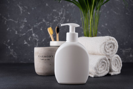 White empty shampoo or lotion bottle for mock-up in modern dark bathroom interiorの写真素材