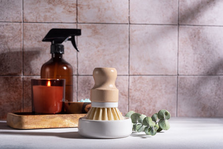 Eco friendly bathroom concept. Sea salt in wooden bowl, brush, spray bottle and candle for relax and bath on tile backgroundの写真素材
