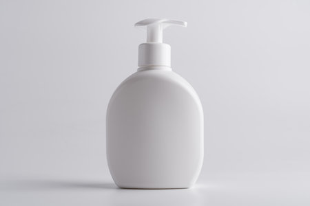 White cosmetic shampoo or lotion dispenser bottle mock-up on grey backgroundの写真素材