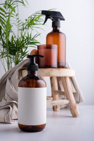 Eco-friendly brown dispenser with shower gel, liquid soap or shampoo on a wooden stool in the bathroomの写真素材