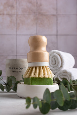 Eco friendly kitchen concept, sustainable lifestyle. Set for cleaning, as dish wash brush, natural soap with eucalyptus and towelsの写真素材