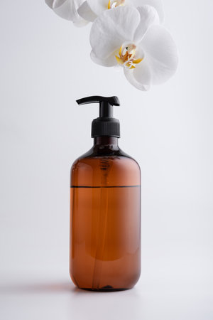 Brown recycled dispenser for organic cosmetic product on grey backgroundの写真素材