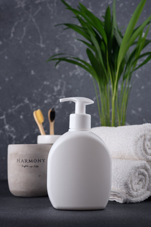 White empty shampoo or lotion bottle for mock-up in modern dark bathroom interiorの写真素材