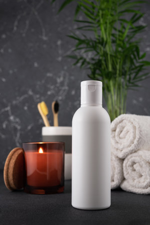 White empty shampoo or lotion bottle for mock-up in modern dark bathroom interiorの写真素材