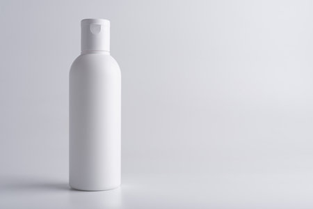 White cosmetic shampoo or lotion bottle mock-up on grey background with copy spaceの写真素材