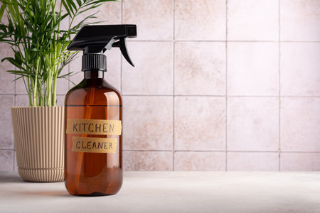 Eco friendly concept, sustainable lifestyle. Spray bottle of kitchen cleaner with home plant on tile background with copy spaceの写真素材