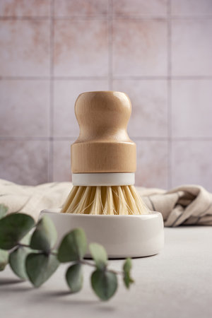 Eco friendly kitchen concept, sustainable lifestyle. Dish wash brush and towel with green eucalyptusの写真素材