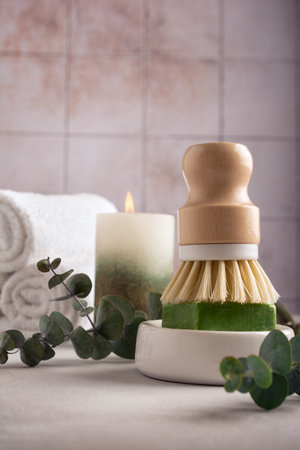 Eco friendly kitchen concept, sustainable lifestyle. Set for cleaning, as dish wash brush, natural soap with eucalyptus and towelsの写真素材