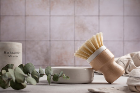 Eco friendly kitchen concept, sustainable lifestyle. Set for cleaning and cozy home, as dish wash brush, towel with eucalyptus and candleの写真素材