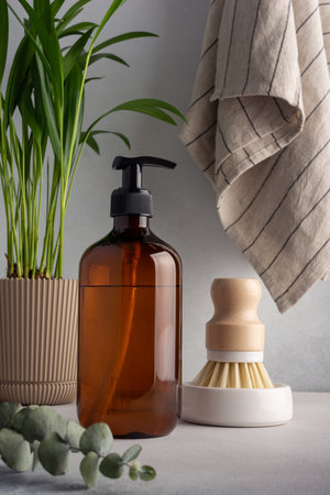 Eco friendly concept, sustainable lifestyle. Set for cleaning, as dish wash brush, kitchen cleaner with home plant, eucalyptus and towelの写真素材