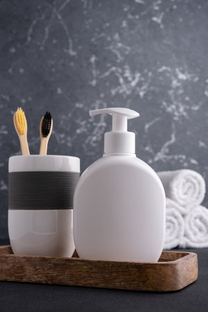 White empty shampoo or lotion bottle for mock-up in modern dark bathroom interiorの写真素材