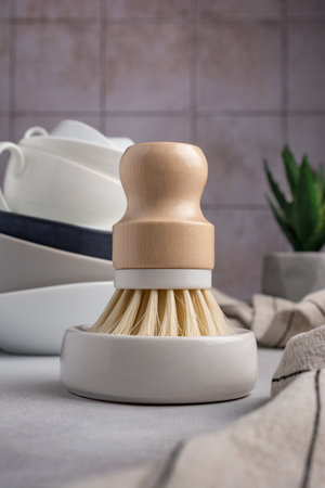 Eco friendly kitchen concept, sustainable lifestyle. Dish wash brush and towel on the table and tile backgroundの写真素材