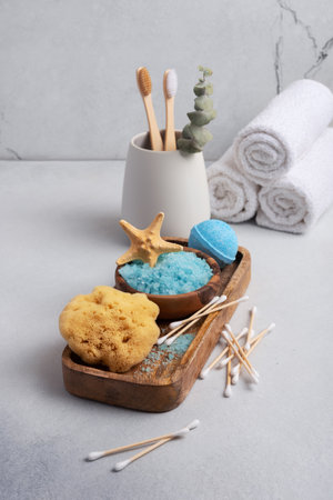 Bath Spa Setting with blue sea salt, natural wild sponge and bamboo toothbrushes. Concept for sustainable leaving.の写真素材