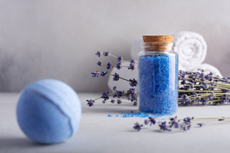 Homemade lavender bath salt in glass jar and bath ball. Wellness concept and spa product.の写真素材