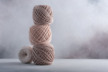 Stack of cotton threads pastel color skeins for craft and handmade on a gray backgroundの写真素材