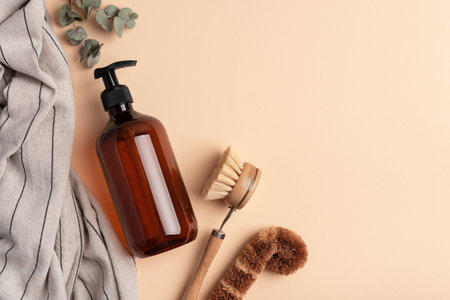 Eco wooden dish brush and dispenser bottle.  Kitchen cleaning concept for eco-friendly lifestyle.の写真素材