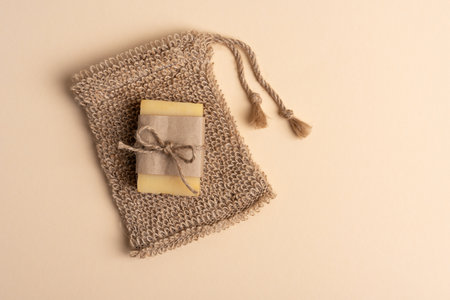Eco friendly and zero waste natural hygiene concept. Diy sisal washcloth with solid soap on beige background.の写真素材