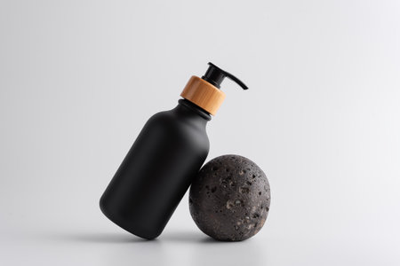 Black bottle with dispenser pump for liquid soap, gel, lotion, cream, shampoo and other cosmetics. Blank product packaging mockup template design.の写真素材