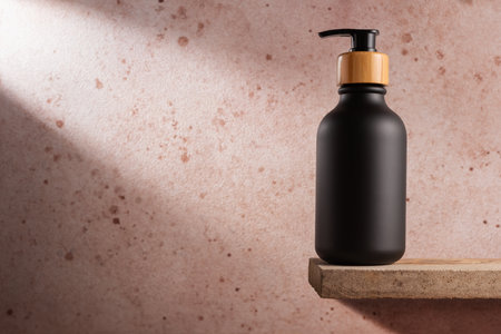 Black bottle with dispenser pump for liquid soap, gel, lotion, cream, shampoo and other cosmetics. Blank product packaging mockup template design.の写真素材