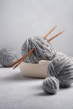 Gray balls of thread with wooden knitting needles. Needlework and leisure concept.の写真素材