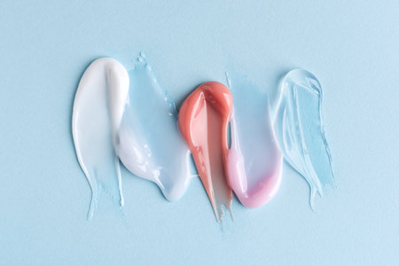 Different pattern cosmetic smears texture on blue pastel backgroundの写真素材